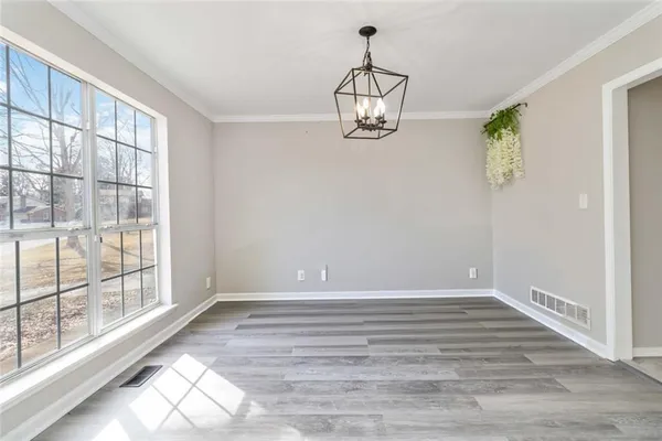 a view of an empty room with window and fireplace