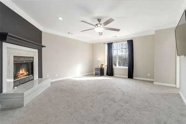 a view of a livingroom with a ceiling fan and a window