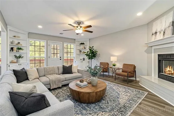 a living room with furniture and a fireplace