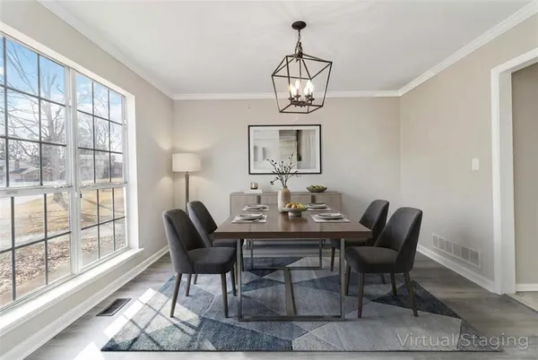 a view of a dining room with furniture wooden floor and chandelier