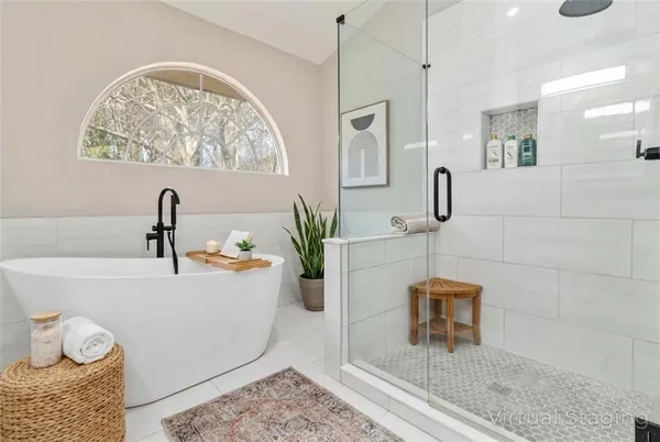 a bathroom with a bathtub sink and mirror
