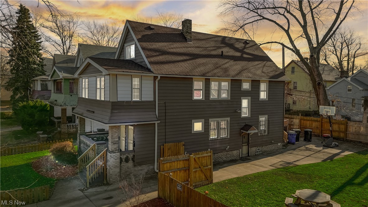 14202 Glenside Road Cleveland, OH 44110 - Photo 2 of 41 Front house at dusk with a lawn