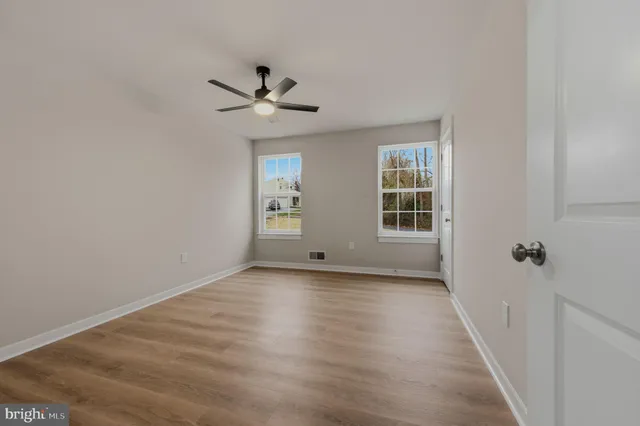 a view of a livingroom with a ceiling fan and window