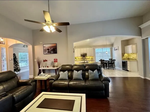 a living room with furniture and a wooden floor