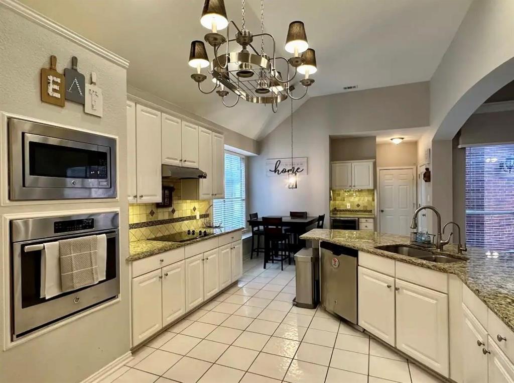 3607 Sable Ridge Drive Dallas, TX 75287 - Photo 12 of 30 a kitchen with a sink stove and cabinets
