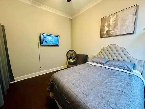 a bedroom with a bed and a wall painting