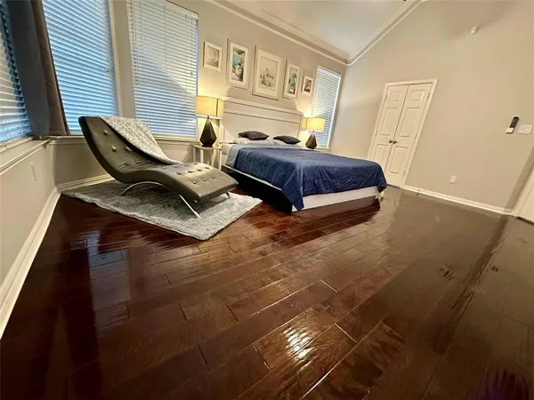 a bedroom with double bed and a window