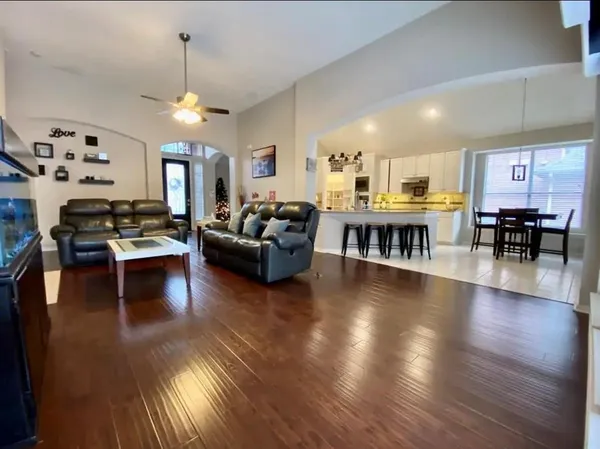 a living room with fireplace furniture and a wooden floor