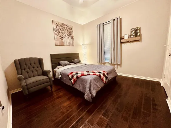 a bed sitting in a bedroom next to a window