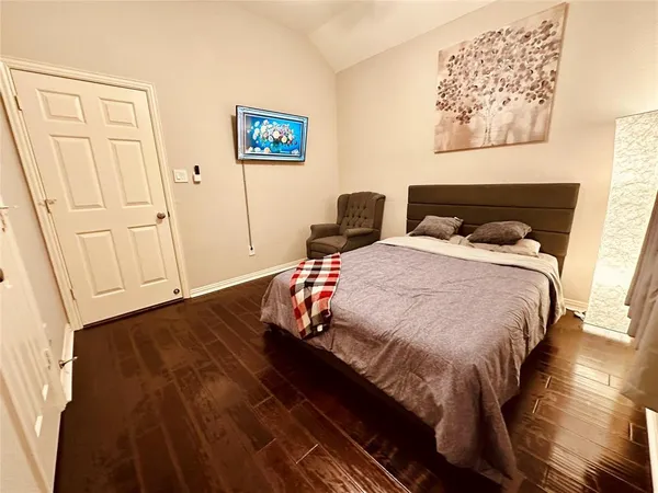 a bedroom with a bed and a wall painting