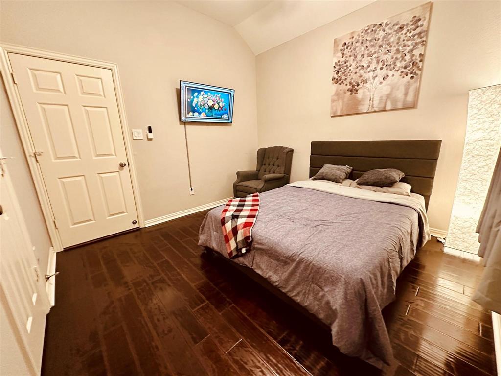 3607 Sable Ridge Drive Dallas, TX 75287 - Photo 23 of 30 a bedroom with a bed and a wall painting