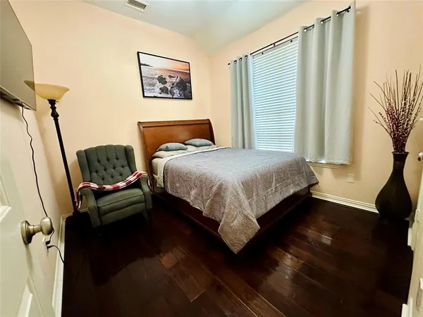 a bedroom with a bed window and a couch