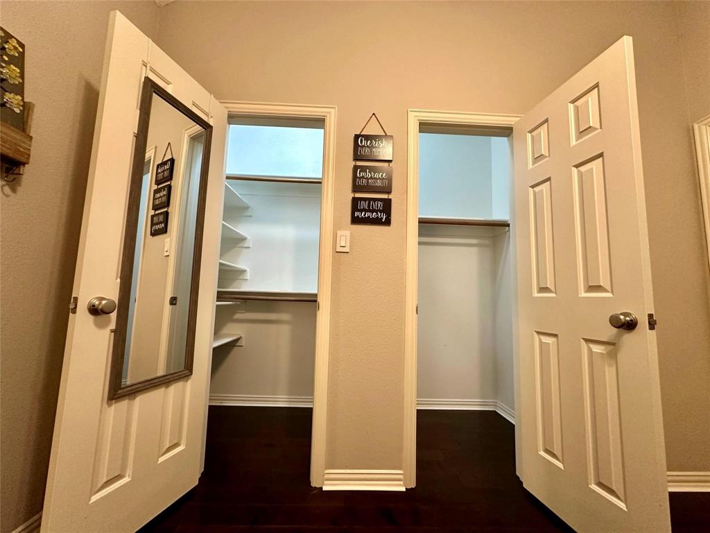 3607 Sable Ridge Drive Dallas, TX 75287 - Photo 25 of 30 a view of walk in closet with wooden floor