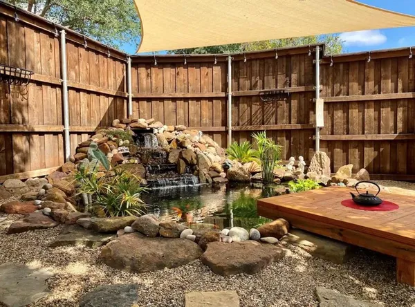 a backyard of a house with wooden floor and outdoor seating