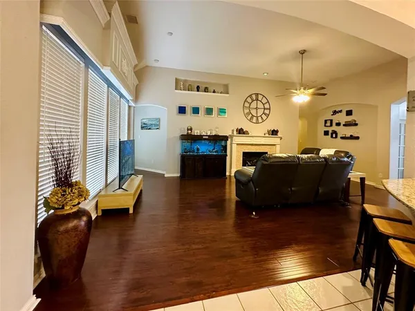 a living room with fireplace furniture and a wooden floor