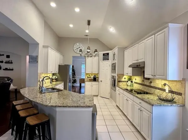 a kitchen with sink stove and cabinets