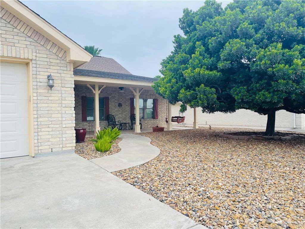 View of yard featuring a garage and covered porch