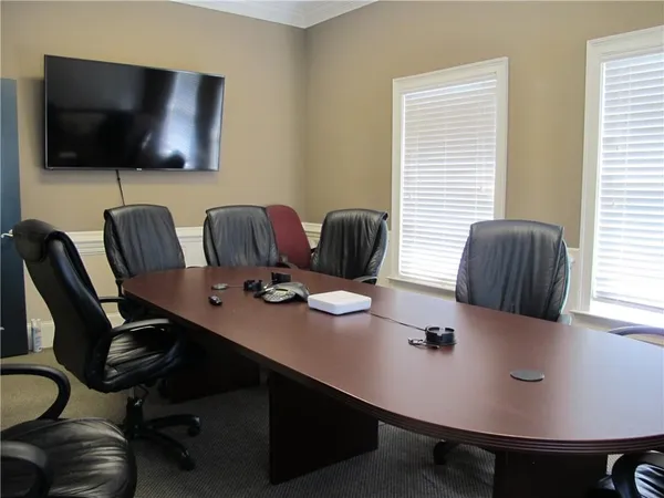 a view of a workspace with furniture and a window