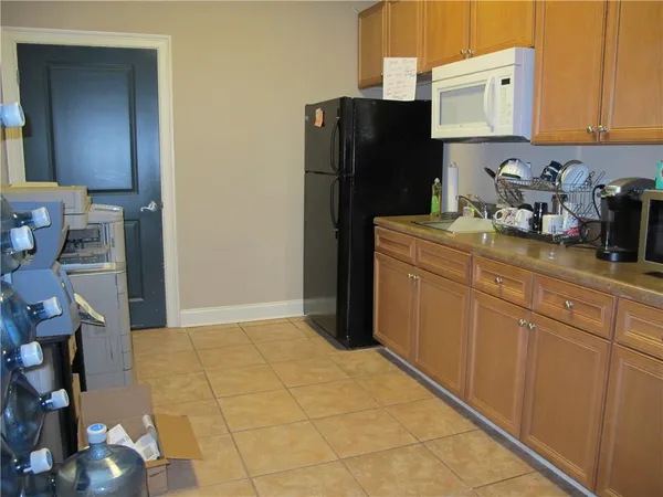 a kitchen with stainless steel appliances a refrigerator sink and cabinets