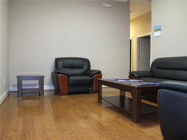 a living room with furniture and a piano