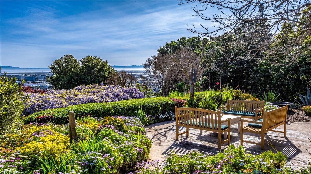 819 Holly Road Belmont, CA 94002 - Photo 13 of 75 a view of a chair and table in the garden