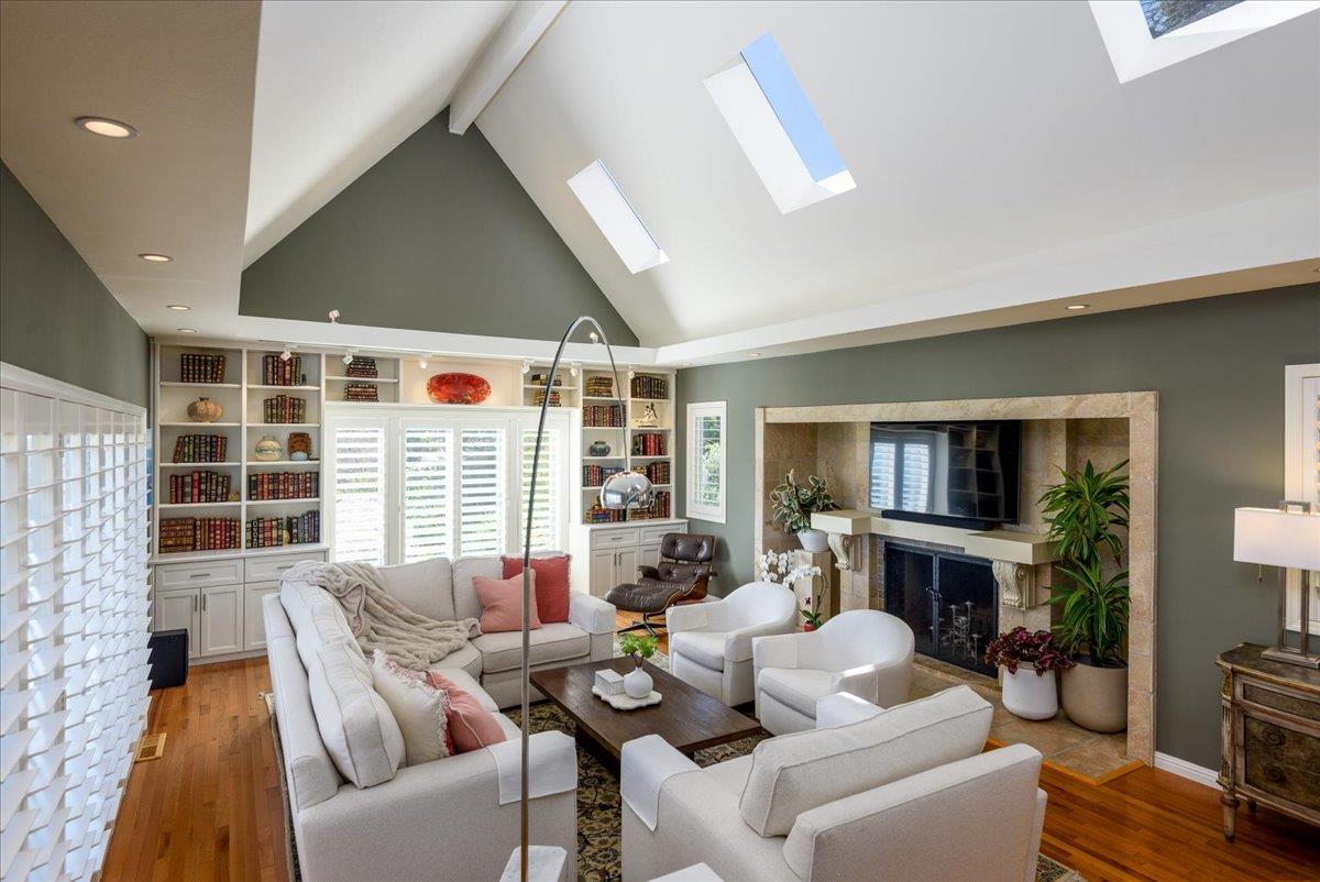 819 Holly Road Belmont, CA 94002 - Photo 20 of 75 a living room with furniture a fireplace and a flat screen tv