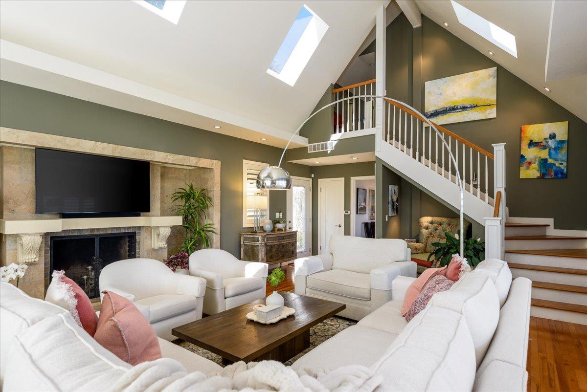 819 Holly Road Belmont, CA 94002 - Photo 22 of 75 a living room with furniture fireplace and a flat screen tv