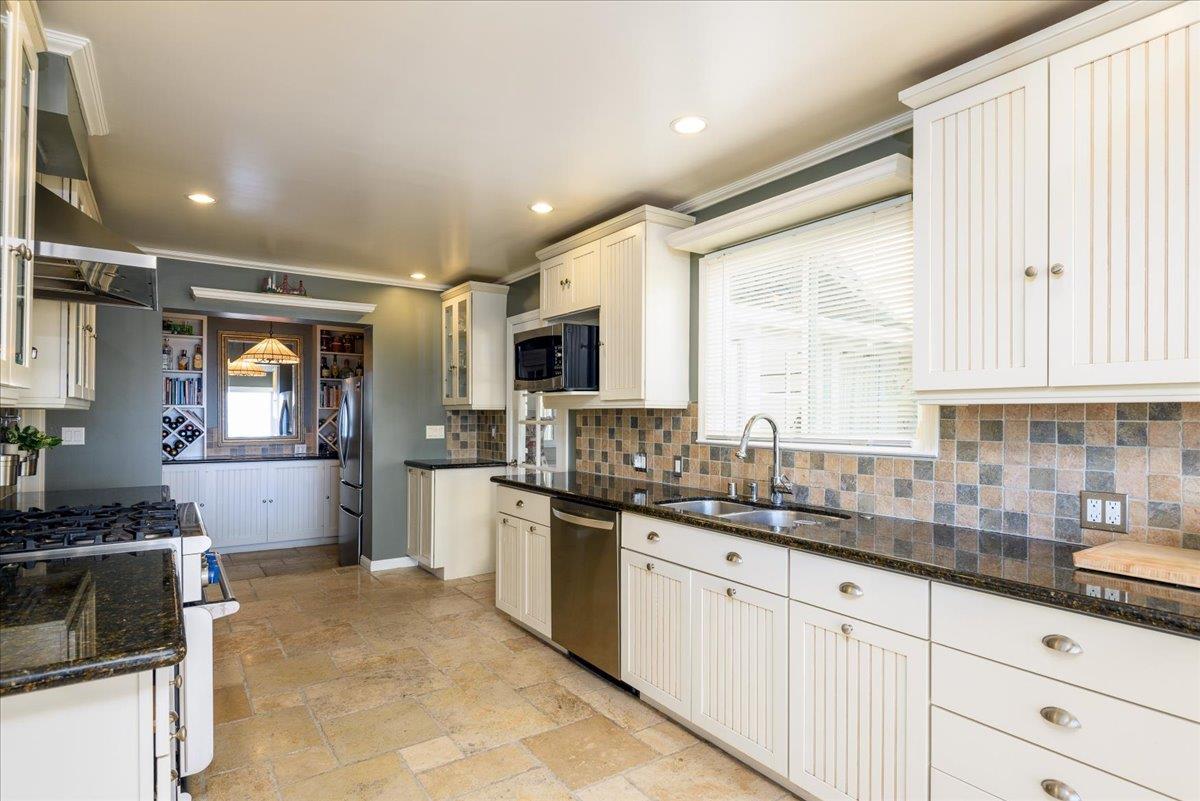 819 Holly Road Belmont, CA 94002 - Photo 26 of 75 a kitchen with granite countertop a sink stainless steel appliances and cabinets