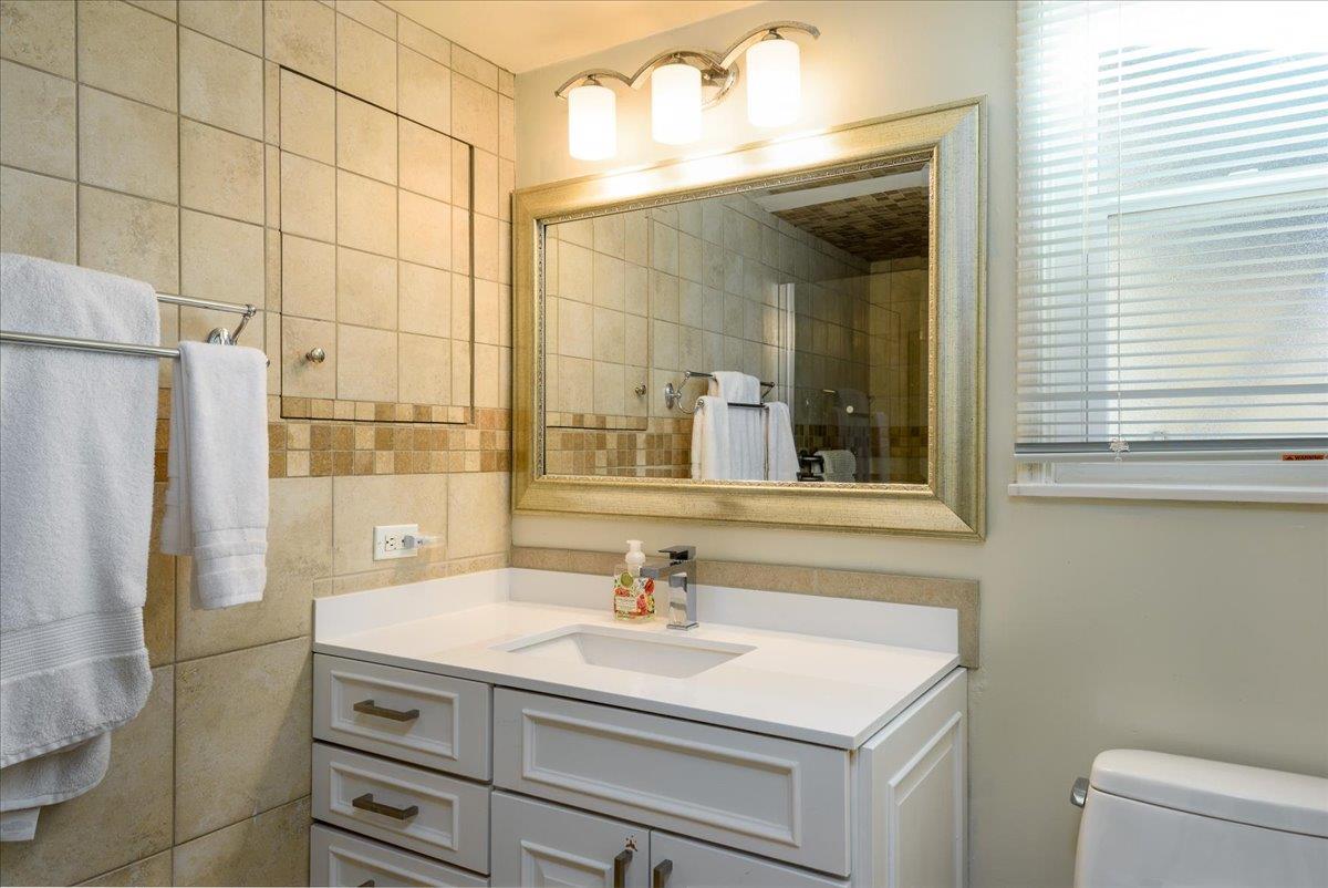 819 Holly Road Belmont, CA 94002 - Photo 28 of 75 a bathroom with a sink and a mirror
