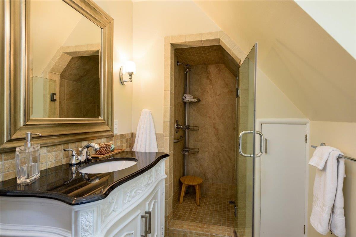819 Holly Road Belmont, CA 94002 - Photo 34 of 75 a bathroom with a granite countertop sink and a mirror