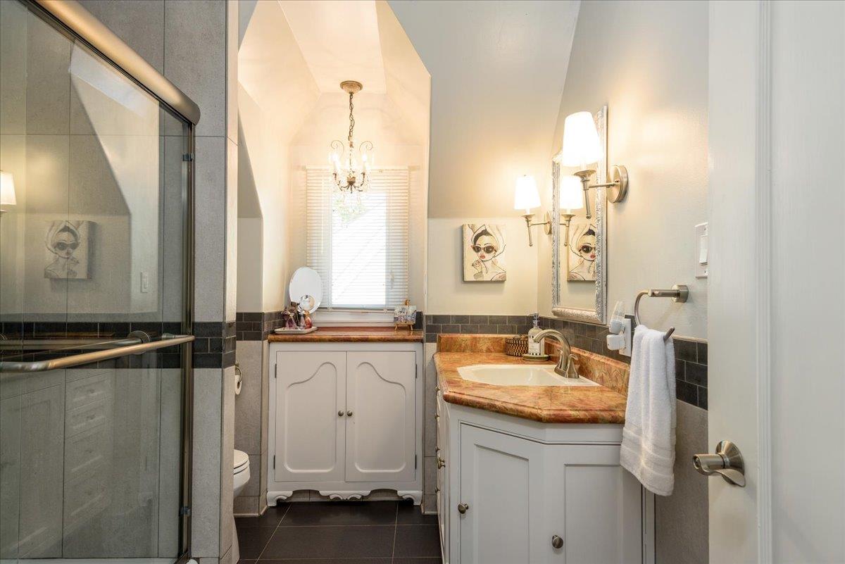 819 Holly Road Belmont, CA 94002 - Photo 38 of 75 a bathroom with a granite countertop sink and a mirror