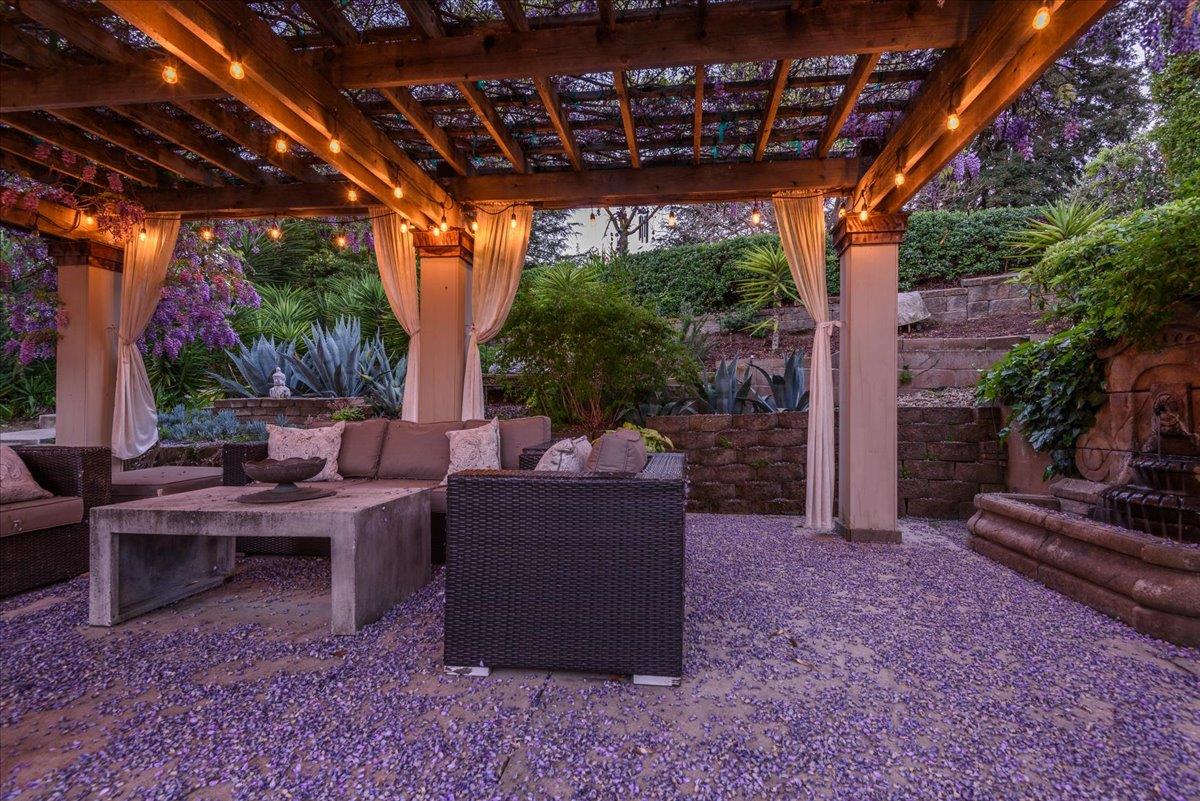819 Holly Road Belmont, CA 94002 - Photo 73 of 75 a view of a patio with couches and table and chairs with wooden fence