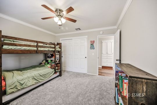 725 West Howell Avenue Ridgecrest, CA 93555 - Photo 24 of 35 a bedroom with a bed and a ceiling fan
