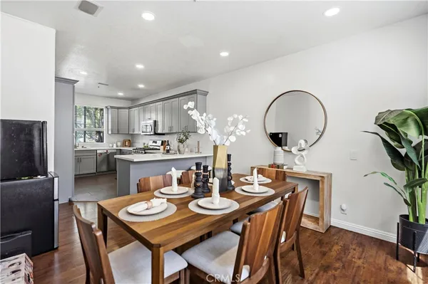 a kitchen with a sink a window and chairs