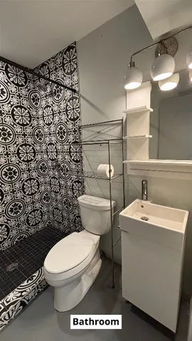 a bathroom with a sink a toilet and a mirror