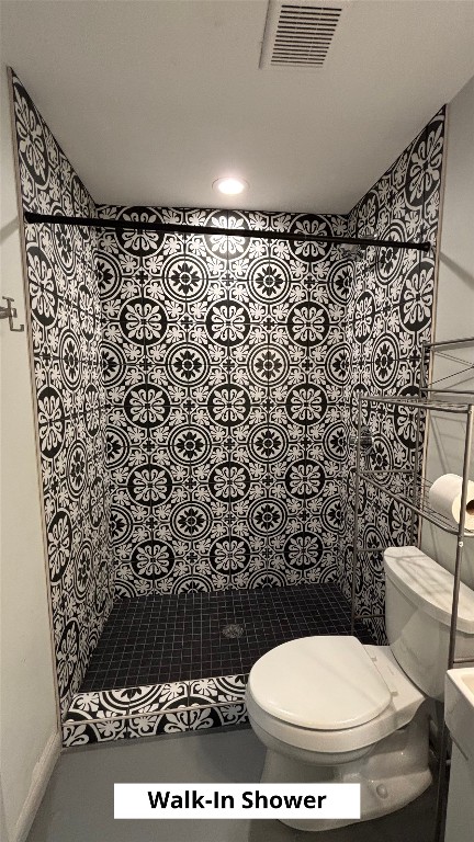 4505 Teri Road, Unit B Austin, TX 78744 - Photo 12 of 22 a bathroom with a toilet and a shower curtain