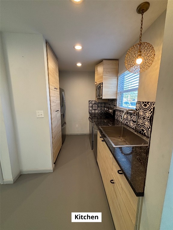 4505 Teri Road, Unit B Austin, TX 78744 - Photo 5 of 22 a kitchen with stainless steel appliances granite countertop a sink a stove and a refrigerator