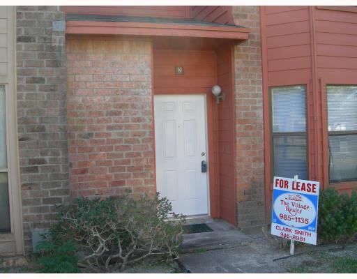 a brick building with a street sign on it