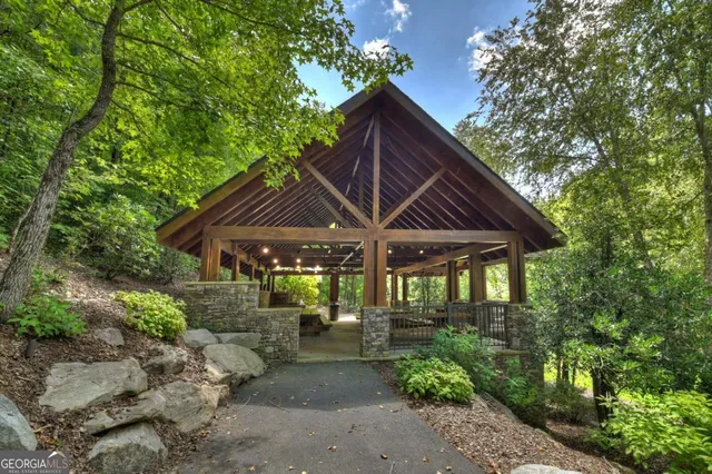 a green field with trees in the background