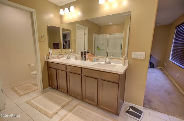 a bathroom with a double vanity sink and mirror