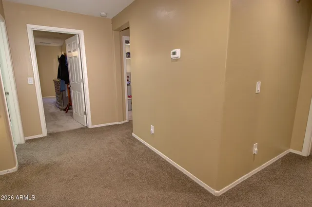 an empty room with closet and wooden door