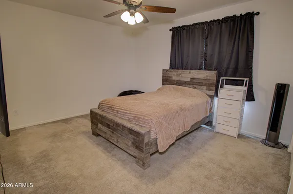 a bed room with a bed and a television