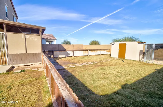 a view of a house with a backyard