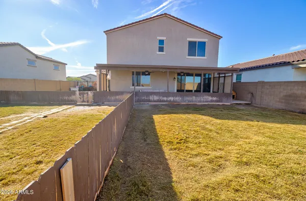 a back yard with wooden fence