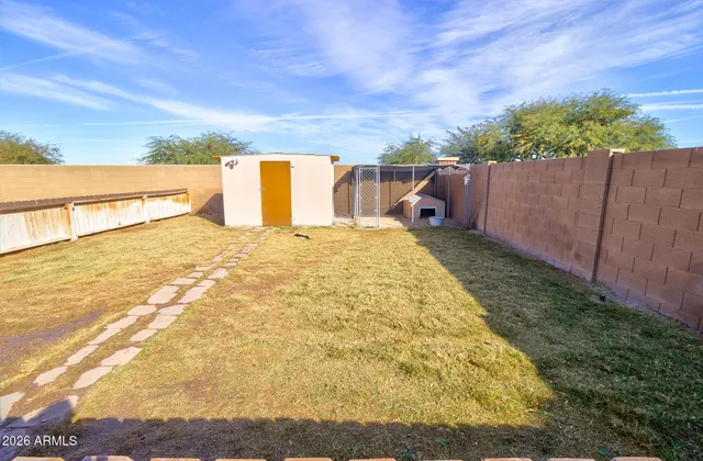 a view of a house with wooden fence