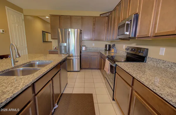 a kitchen with a sink stove and refrigerator