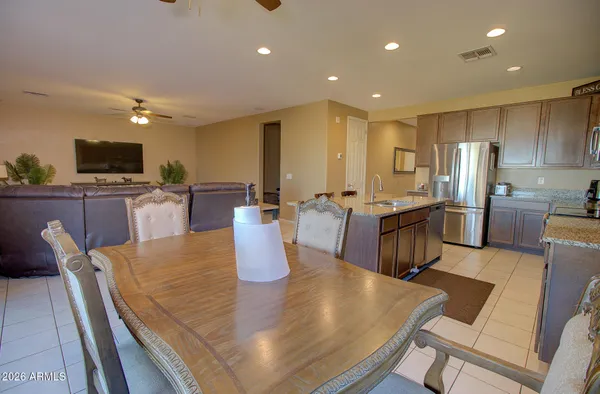 a large kitchen with a table and chairs
