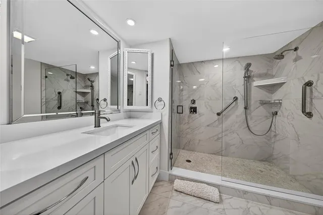 a bathroom with a shower sink and mirror
