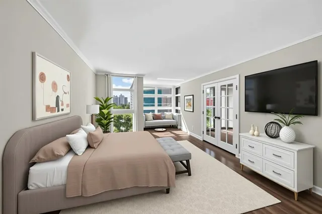 a bedroom with furniture and a flat screen tv