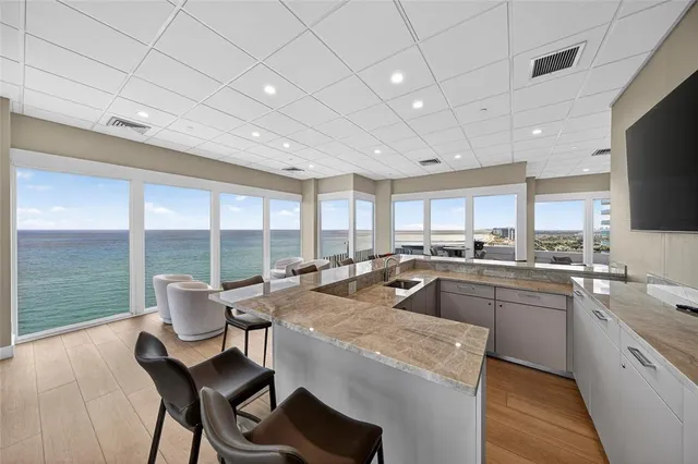 a kitchen with a table chairs microwave and cabinets